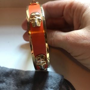 Alexander McQueen gold and orange skull bangle